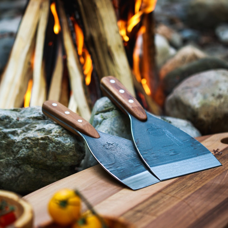 Two Almazan Kitchen spatulas on a cutting board