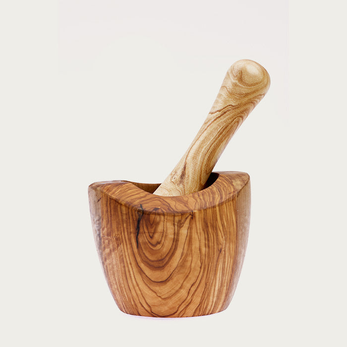 Olive wood mortar and pestle on a white background.