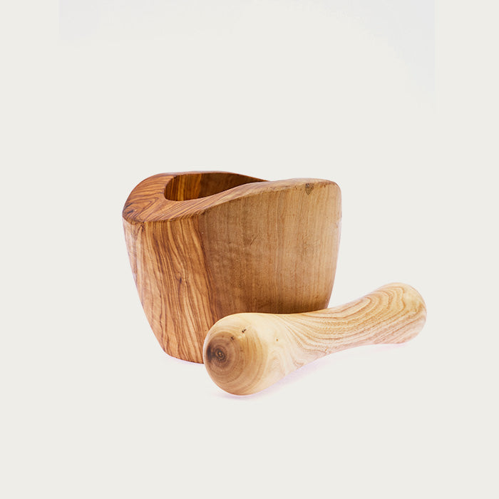 Wooden mortar and pestle on a white background.