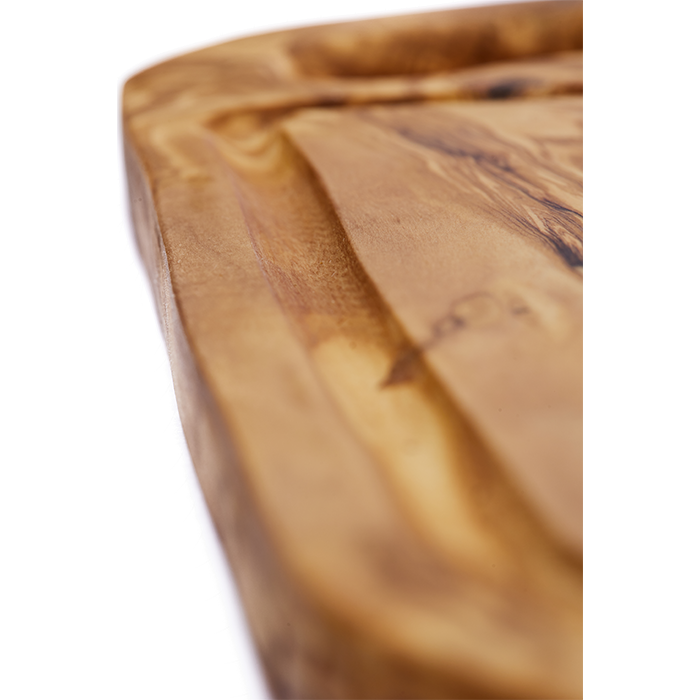 Close up of carved details on a olive wood steak board.