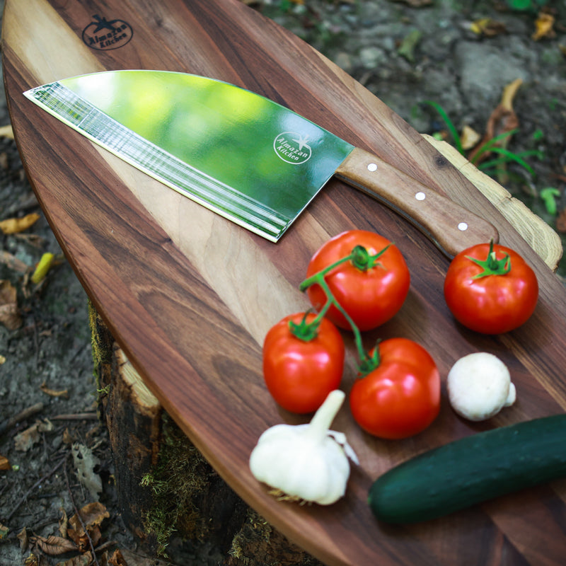 Almazan Kitchen Steak Knife on a cutting board next to vegetables