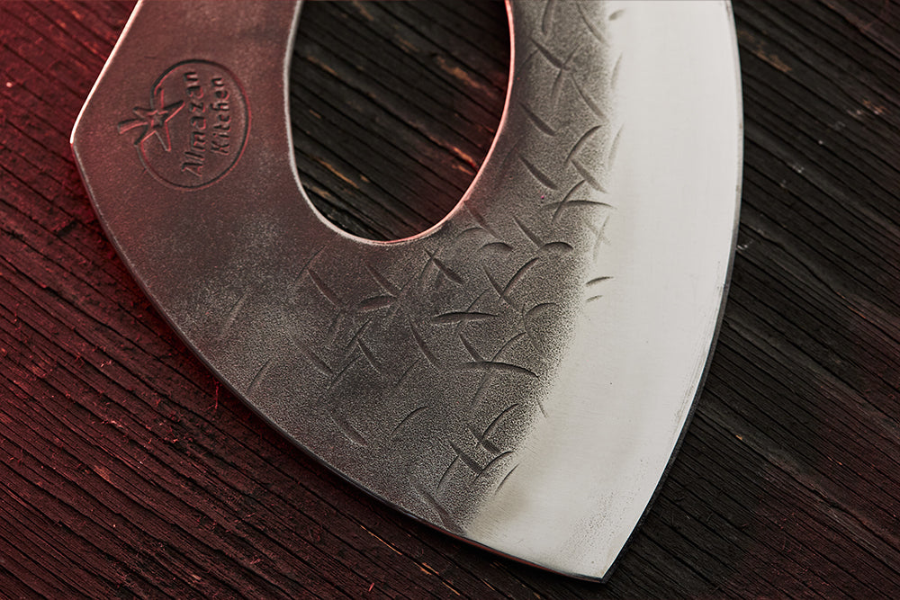 Close up of the forge marks on the head of the Almazan Kitchen cooking axe.