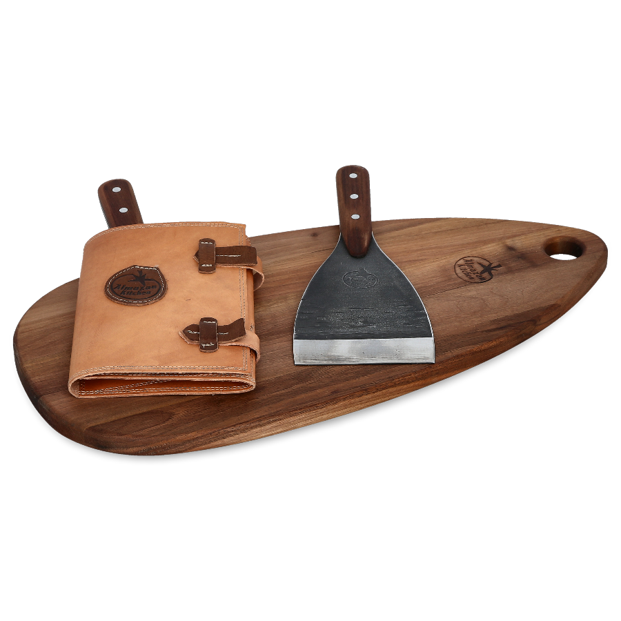 Two Almazan Kitchen Spatulas on a cutting board, one sheathed one unsheathed