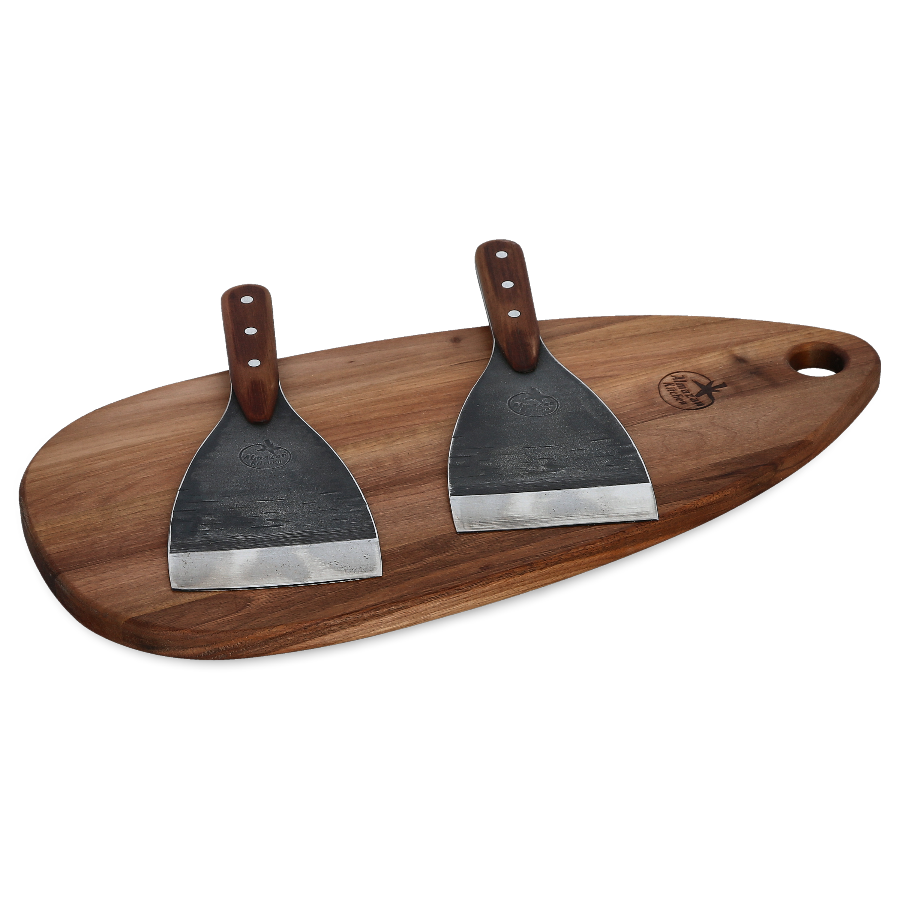 Two Almazan Kitchen Spatulas on a cutting board