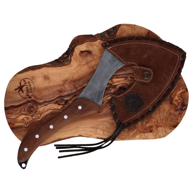Almazan Kitchen Carbon Cooking Axe in a brown leather sheath in on a cutting board