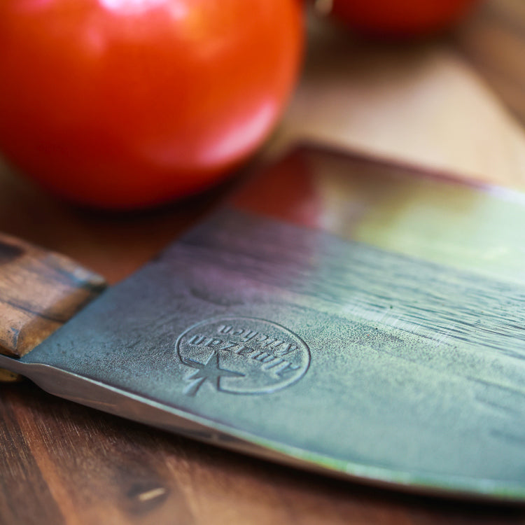 Close up of the Almazan Kitchen logo on the blade of a Serbian Chef Knife