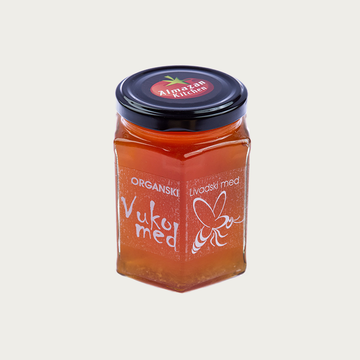 Almazan Kitchen's organic meadow honey in a glass jar on a white background.