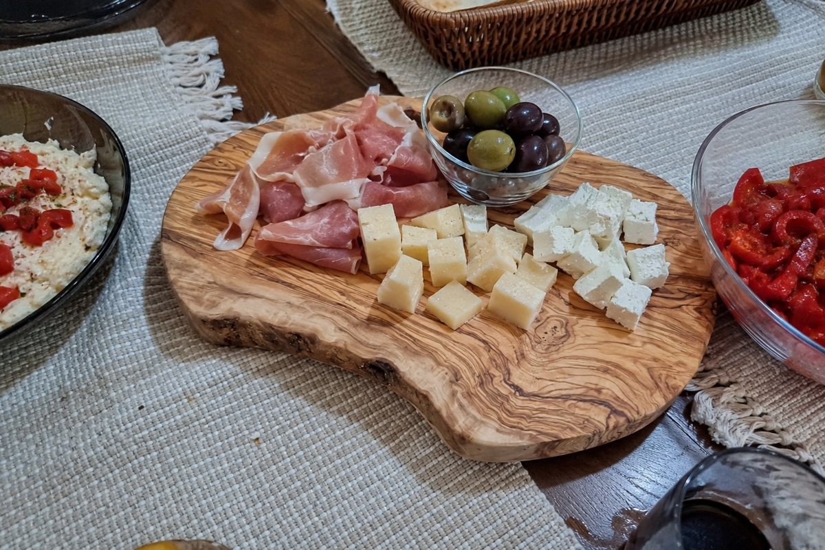 Rustic olive-wood board with a charcuterie spread