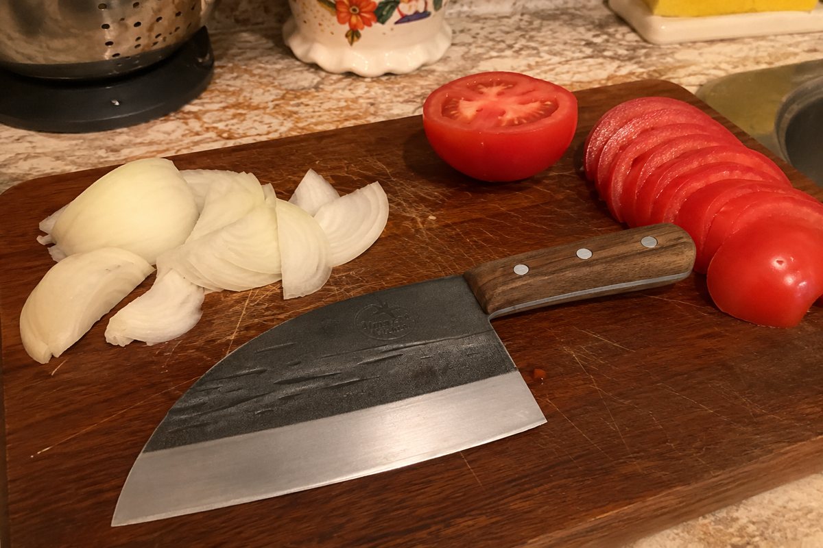 Serbian chef knife with sliced tomato and onion