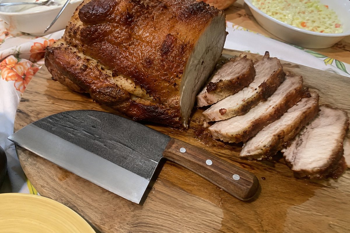 Serbian chef knife with a Sunday roast on the board